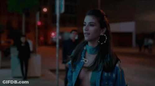 Woman In Blue Jacket Walking City Street At Night GIF