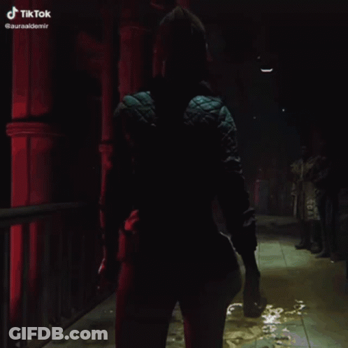 Woman In Blue Jacket Walking Dark Hallway TikTok GIF