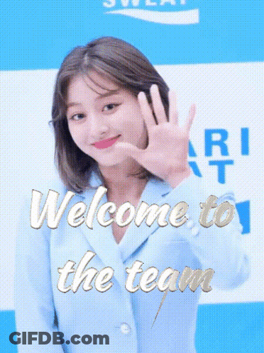 Woman In Blue Jacket Waving At Welcome To The Team Sign GIF