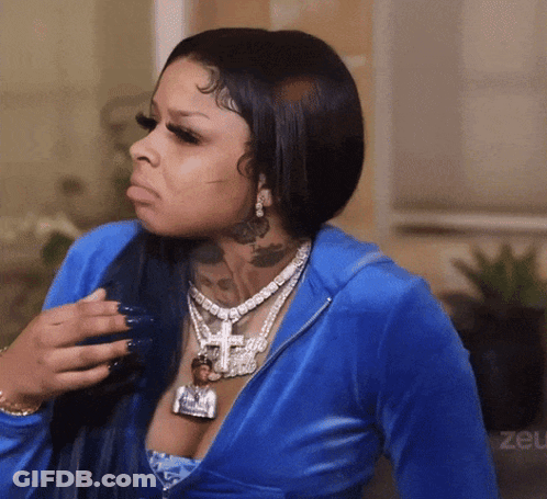 Woman In Blue Jacket With Cross Necklace GIF