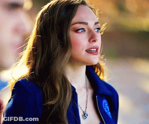 Woman In Blue Jacket With Heart Necklace GIF