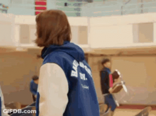 Woman In Blue Jacket With Hood In Gym GIF