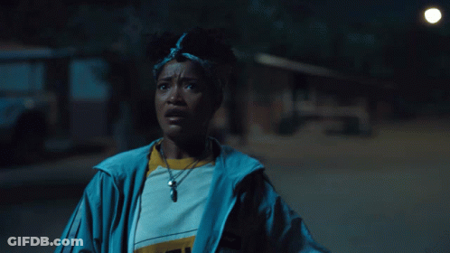 Woman In Blue Jacket With Pendant Saying I GIF