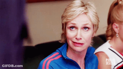 Woman In Blue Jacket With Red Stripes Sitting In Front Of Fox Sign GIF
