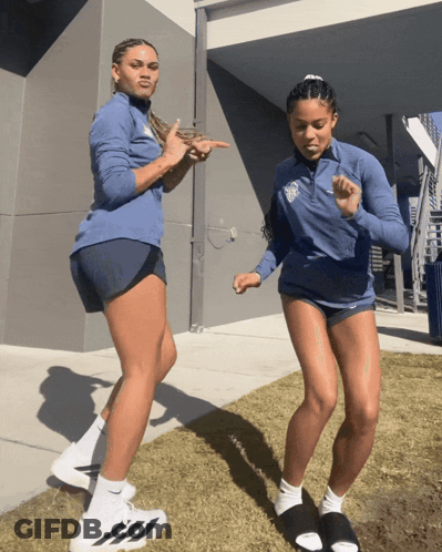Woman In Blue Jacket With UCSD Logo Next To Woman In Shorts GIF