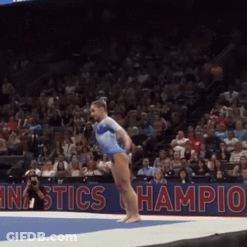 Woman In Blue Leotard Doing Gymnastics Trick GIF