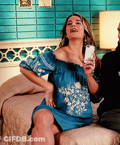 Woman In Blue Off The Shoulder Dress Holding Cell Phone GIF