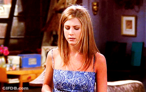 Woman In Blue Paisley Top Standing In Living Room GIF