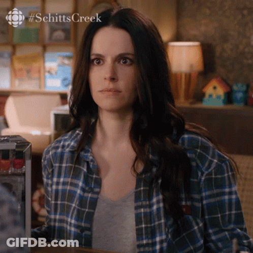 Woman In Blue Plaid Shirt Sitting At Table #SchittsCreek GIF