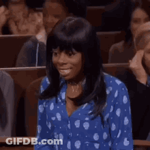 Woman In Blue Polka Dot Shirt Smiling In Crowd GIF