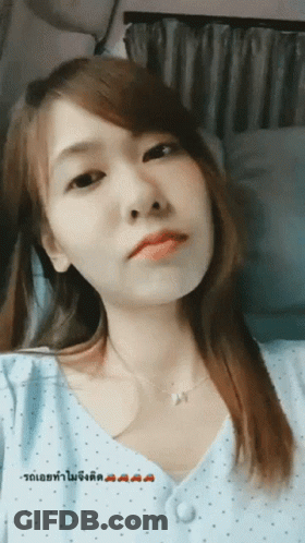 Woman In Blue Polka Dot Shirt With Foreign Language GIF