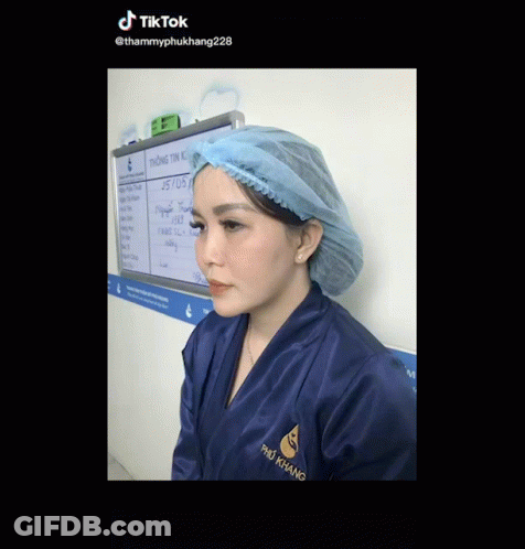 Woman In Blue Robe And Surgical Cap At Whiteboard Saying Tik Tok GIF