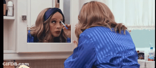 Woman In Blue Robe Applying Makeup GIF