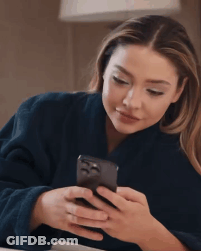 Woman In Blue Robe Checking Phone GIF