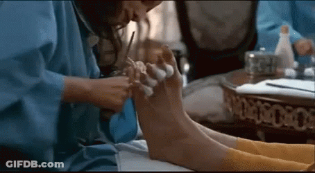 Woman In Blue Robe Giving Pedicure GIF