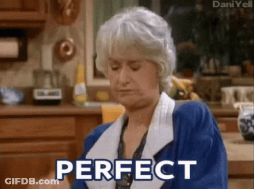 Woman In Blue Robe Sitting In Kitchen GIF