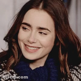 Woman In Blue Scarf And Plaid Coat Smiling GIF