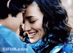 Woman In Blue Scarf Smiling As Man Kisses Forehead GIF