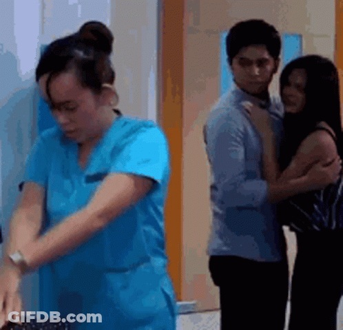 Woman In Blue Scrub Next To Man And Woman GIF