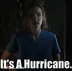Woman In Blue Scrub Top Saying It's A Hurricane GIF