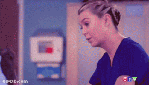 Woman In Blue Scrub Top Talking To Doctor GIF
