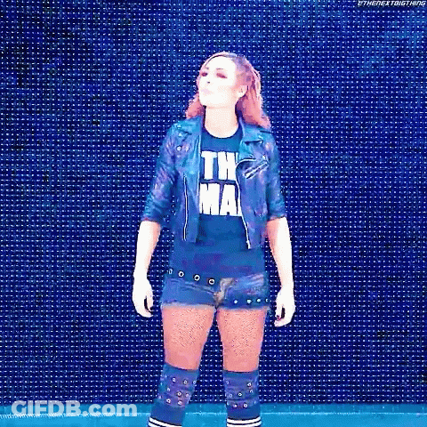 Woman In Blue Shirt And Denim Shorts In Front Of Blue Screen GIF