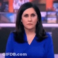 Woman In Blue Shirt And Earrings Looking At Camera GIF