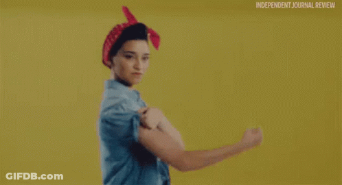 Woman In Blue Shirt And Red Bandana Flexing Muscles GIF