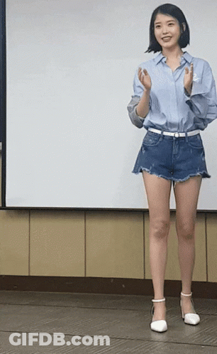 Woman In Blue Shirt And Shorts In Front Of White Board GIF