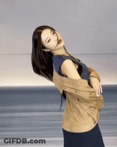 Woman In Blue Shirt And Tan Jacket GIF