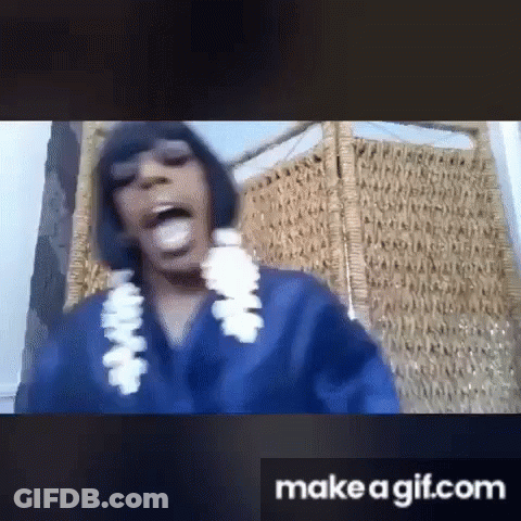 Woman In Blue Shirt And White Lei Sitting In Chair GIF