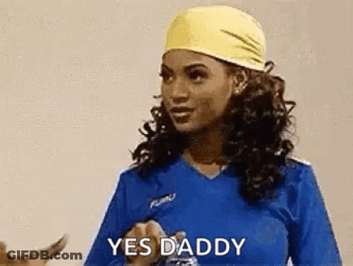 Woman In Blue Shirt And Yellow Headband Saying Yes Daddy GIF