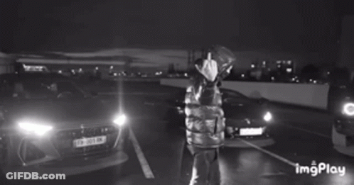 Woman In Blue Shirt Arms In Air Saying Alive & Well GIF
