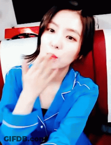 Woman In Blue Shirt Blowing Kiss GIF