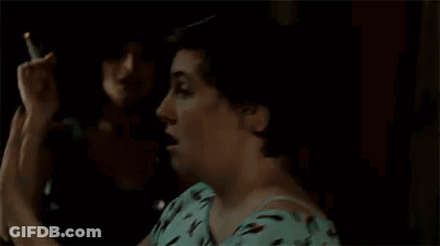 Woman In Blue Shirt Covering Eyes In Dark Room GIF
