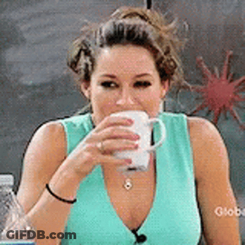 Woman In Blue Shirt Drinking From White Cup GIF