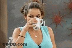 Woman In Blue Shirt Drinking From White Cup GIF