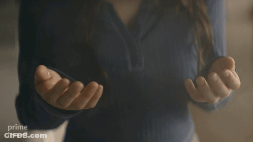 Woman In Blue Shirt Gesturing At Amazon Prime Logo GIF