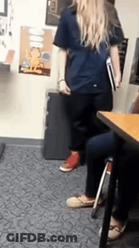 Woman In Blue Shirt Holding Book GIF