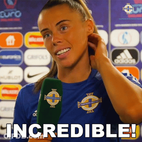 Woman In Blue Shirt Holding Green Microphone Says Incredible GIF