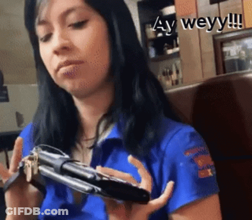 Woman In Blue Shirt Holding Phone And Keys GIF