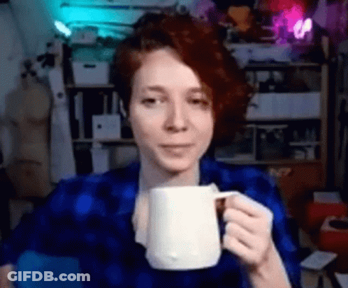 Woman In Blue Shirt Holding White Mug GIF