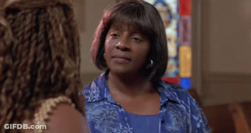 Woman In Blue Shirt In Church With Stained Glass Window GIF