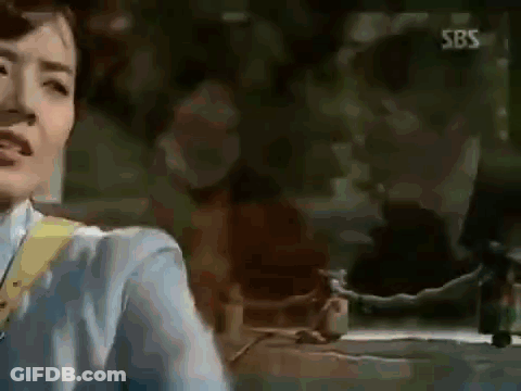Woman In Blue Shirt In Front Of SBS Sign GIF