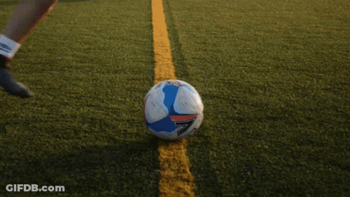 Woman In Blue Shirt Kicking Soccer Ball GIF