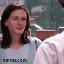 Woman In Blue Shirt Looking At Man In Pink GIF