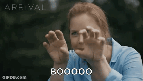 Woman In Blue Shirt Making Funny Face Saying Boooo GIF