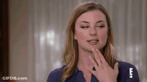 Woman In Blue Shirt Making Funny Face With Hand On Face GIF