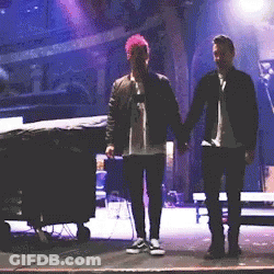 Woman In Blue Shirt Next To Man In White Fila Shirt GIF
