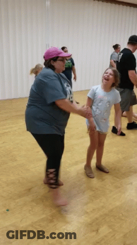 Woman In Blue Shirt Number 18 Holding Hands With Little Girl GIF